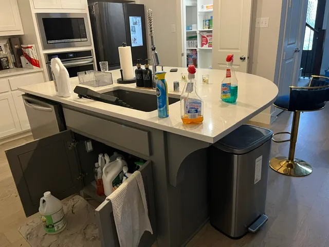 Before cleaning: Cluttered kitchen island with unwashed dishes