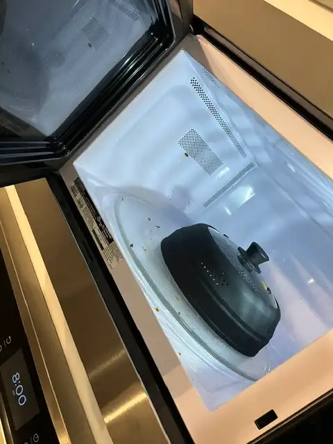 Before cleaning: Microwave interior with food splatters